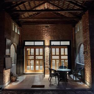 a patio with a table and chairs in a brick building at Tenuta Castello in Cerrione