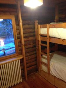 a room with two bunk beds and a window at Haut vue Cervin Matterhorn in Antey-Saint-André