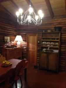 a dining room with a table and a chandelier at Haut vue Cervin Matterhorn in Antey-Saint-André