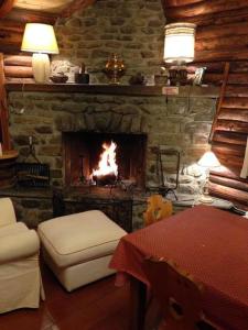 a living room with a fireplace with a fire in it at Haut vue Cervin Matterhorn in Antey-Saint-André