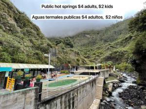 a bridge over a river in a mountain at Mountain Chalet - Tungurahua Hot Springs/Aguas Termales in Baños
