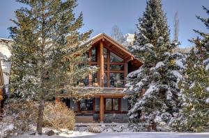 a log home in the snow with trees at Glacier View Chalet - Tranquil Chalet with Private Hot Tub & Golf Course Views - Whistler Platinum in Whistler