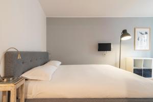 Postel nebo postele na pokoji v ubytování easyhomes - Spiga Suite