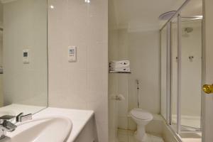 a bathroom with a sink and a toilet and a shower at The Capetonian - Halaal in Cape Town