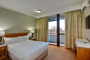 a hotel room with a bed and a window at The Capetonian - Halaal in Cape Town