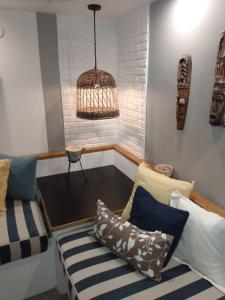 a living room with a couch and a bird cage at CASA NELLY by ABORIGEN APARTAMENTOS BOUTIQUE in Puerto Madryn