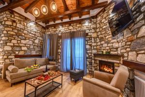 a living room with a stone wall at Mple Feggari in Mouresi