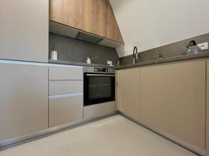 a kitchen with white cabinets and an oven at Villa Anemar in Blidinje