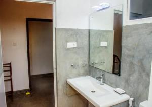 a bathroom with a sink and a mirror at Kurundu Wadiya (Cinnamon Retreat) in Hikkaduwa