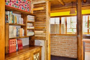 eine Bibliothek mit Holzregalen und Büchern in der Unterkunft Loft de montaña Los Guayacanes in San José de Maipo