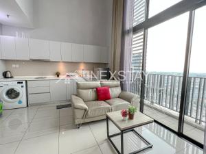 a living room with a couch and a kitchen at Cozy i-City Duplex Getaway by Nexstay in Shah Alam