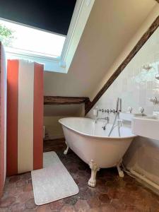 a bathroom with a large tub and a sink at Suite Versailles Quartier Saint-Louis 6 personnes in Versailles