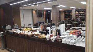 a buffet line with food on it in a restaurant at Hotel Maravilha in Caçapava do Sul