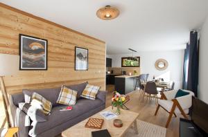 a living room with a couch and a table at Résidence Provençal by Leavetown Vacations in Les Deux Alpes