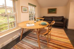 a living room with a table and a couch at Fold Cottage, Outgate near Ambleside in Hawkshead