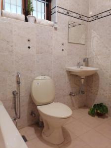 a bathroom with a toilet and a sink at Surendram Villa in Varkala +30 photos