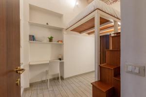 a room with a loft bed and a desk at Carini House Near the Cathedral by Wonderful Italy in Palermo