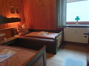 um pequeno quarto com 2 camas e um lavatório em Urig mitten im Bayerischen Wald mit traumhaften Fernblick WLAN kostenfrei em Schöfweg