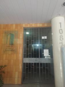 a glass door to a building with a sign on it at Casa da Nanda in Fortaleza