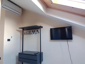 a flat screen tv on a wall in a room at San Rocco Rooms in Palmi +32 photos