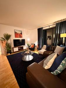 a living room with a couch and a table at NEW Spacious 2 bedroom Apartment with Balcony in London