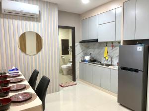 eine Küche mit einem Tisch und einem Kühlschrank in der Unterkunft 2 Bedroom 1602 at Formosa Residence Nagoya With Netflix by Wiwi in Nagoya