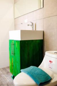 a bathroom with a green sink and a toilet at Art Villa Dominicana in Punta Cana