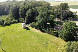 an overhead view of a small building on a field with trees at Tiny House nature proche Montargis - 1h de Paris ! 