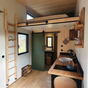 a tiny house with a bunk bed and a desk at Tiny House nature proche Montargis - 1h de Paris ! 