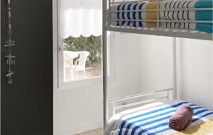 a bunk bed in a room with a window at 2 Bedroom Amazing Home In Jard-sur-mer in Jard-sur-Mer