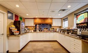a large kitchen with white cabinets and a counter at Comfort Inn & Suites North Conway in North Conway