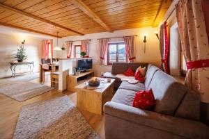 a living room with a couch and a table at Langerbauer-Hof in Ruhpolding