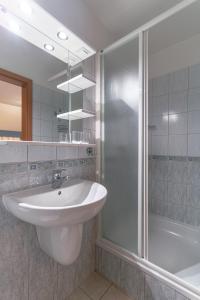 La salle de bains blanche est pourvue d'un lavabo et d'une douche. dans l'établissement Fantazja, à Szklarska Poręba