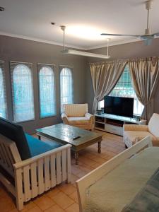 uma sala de estar com um sofá e uma televisão em 20 On Plover - Private Cottage em Sandton