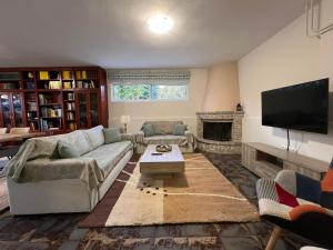 a living room with a couch and a tv at CELENA CITY in Kalamata