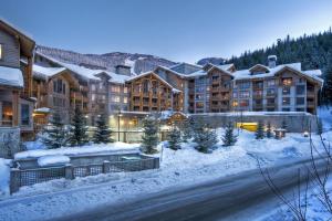 a resort in the winter with snow on the ground at First Tracks Lodge in Whistler