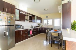 een grote keuken met een tafel en een koelkast bij Central Bliss / your perfect home away from home in Limassol