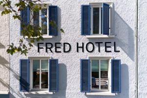 a facade of a fired hotel with blue shutters at Fred Hotel Zürich Hauptbahnhof in Zurich