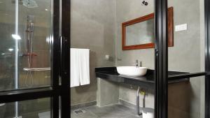 a bathroom with a sink and a shower at Woodgrove Cabanas in Negombo