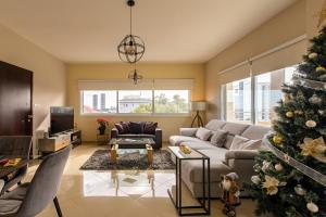 a living room with a christmas tree in it at Central Bliss / your perfect home away from home in Limassol