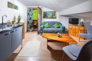a kitchen and living room with a table and a couch at Pension Rennlehen in Berchtesgaden