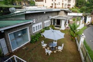 Elle offre une vue sur la terrasse dotée d'une table et d'un parasol. dans l'établissement Funk Bunks - By The Lake, à Kandy