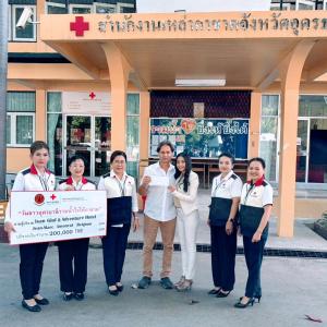a group of people standing in front of a building holding a check at Isan Golf & Adventure Hotel in Udon Thani