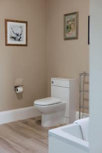 a bathroom with a white toilet and a sink at Horton Inn in Horton