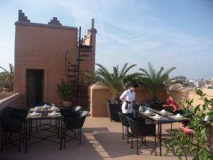 a restaurant with tables, chairs, and tables with umbrellas at Riad Matham in Marrakesh