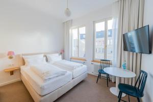 Postel nebo postele na pokoji v ubytování Logierhaus Austernfischer
