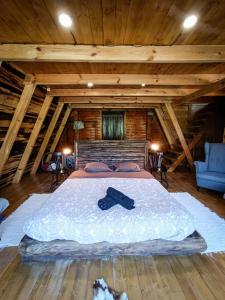 a bedroom with a bed with a black tie on it at Quinta Alma - Ecological Retreat Farm in Aljezur