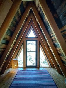 a room with a large window in a roof at Quinta Alma - Ecological Retreat Farm in Aljezur