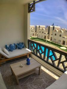a balcony with a couch and a view of a building at Luxury Beach Frontage Studio- Non Egyptians only in Hurghada