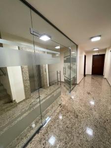 an empty room with a glass door in a building at Luxury Gated Apartment in Sofia